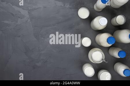 Collection of milk bottles on gray stone background, top view Stock Photo