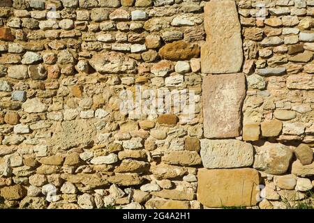 Large vertical stone blocks and small horizontal stones in Roman stone wall construction Stock Photo