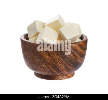 Greek feta cubes in wooden bowl. Diced soft cheese isolated on white background Stock Photo