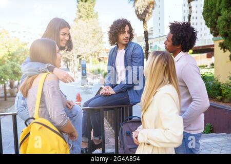 Multi-ethnic group of students talking in the street Stock Photo