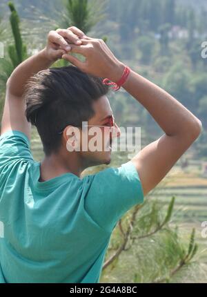 Back view of a young guy wearing sunglass and posing in outdoor Stock Photo