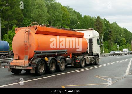 Fuel truck. Carrier of gas products. Transportation of gasoline. Truck on the highway. Dangerous cargo. Tank with fuel. Stock Photo