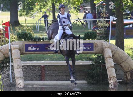 19 June 2021, Lower Saxony, Luhmühlen: Equestrian sport: German Championships, Eventing. The US event rider Ariel Grald rides Leamore Master Plan in the cross-country competition (5*-L). Photo: Friso Gentsch/dpa Stock Photo