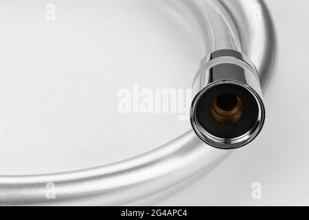 New shower plastic pvc hose on a white background. Field with Clipping Path. Stock Photo