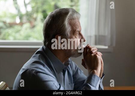 Sad older man look in distance feeling lonely depressed Stock Photo