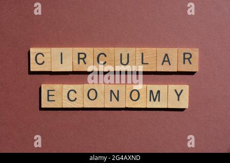 Circular Economy, words in wooden alphabet letters isolated on brown background Stock Photo