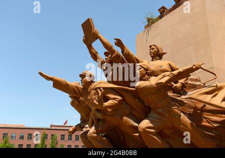 The famous resin statue of Chairman Mao on Zhongshan square in Shenyang, China, includes scenes depicting revolutionary activities from history. Stock Photo