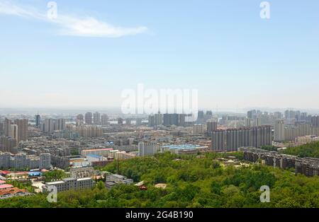 View of the city of Dandong in Liaoning province, with the border city of Sinuju in North Korea beyond the river in the far distance. Dandong, China Stock Photo