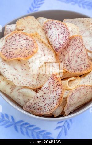 Organic Taro chips inside a bowl Stock Photo