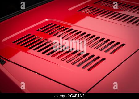 Auto engine grille closeup on a red sport car. Stock Photo