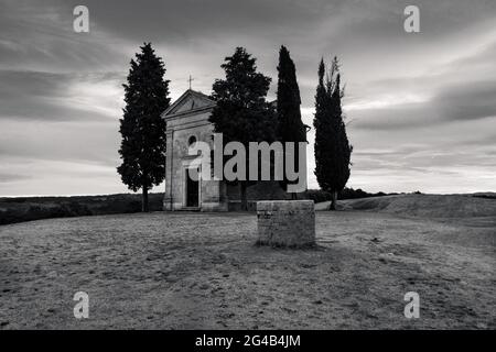 Chapel Capella della Madonna di Vitaleta in Val d' Orcia, Tuscany, Italy at Sunrise or Dawn in Monochrome Black and White Stock Photo