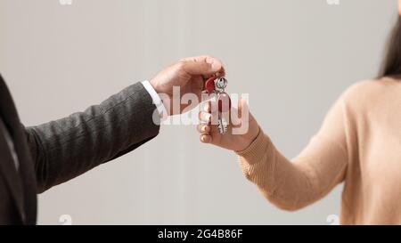 Real Estate Agent Giving Keys To Buyer Stock Photo