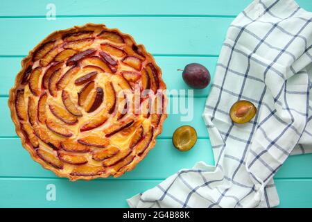 Tasty summer tart with fruits, top view. Homemade pastry with plums. Stock Photo