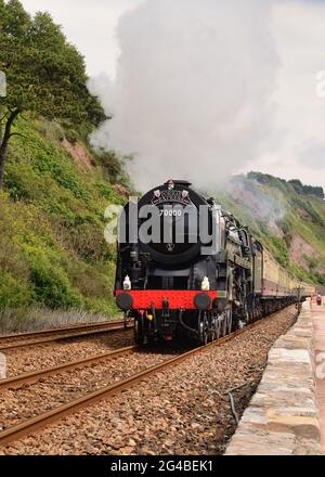 BR Standard class pacific No 70000 Britannia hauling the Torbay Express along the seawall at Teignmouth, heading for Kingswear. 14th June 2015. Stock Photo