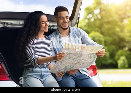 Loving middle-eastern couple watching map while having break Stock Photo