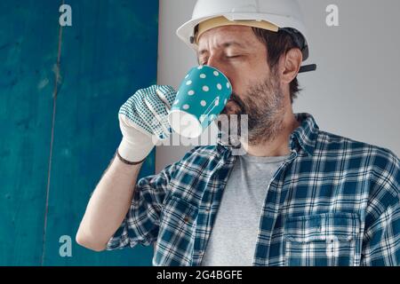 Construction engineer on a morning coffee break, relaxing and preparing for work Stock Photo