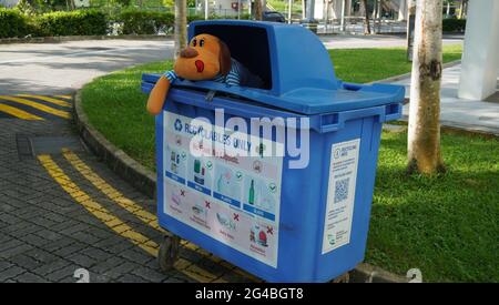 Creative Trash by resident using smart way before throwing a  soft toy into the dustbin in Singapore. Stock Photo