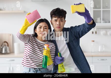 Hard-working asian man and woman house-keeping at kitchen Stock Photo