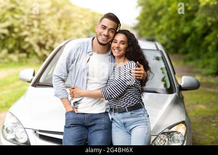 Beautiful multiethnic couple having break while car trip Stock Photo