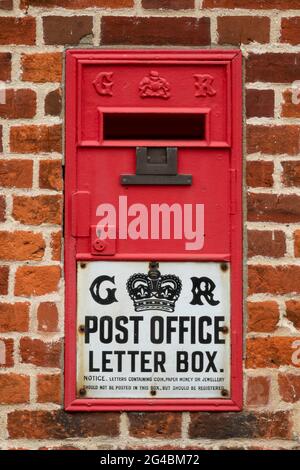 Post Office letter box from King George 5th set into a brick wall Stock Photo