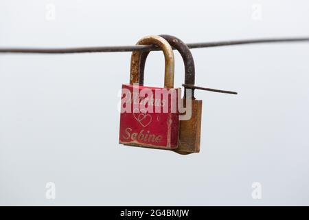 Two love locks hang on a rope on Heligoland. Stock Photo