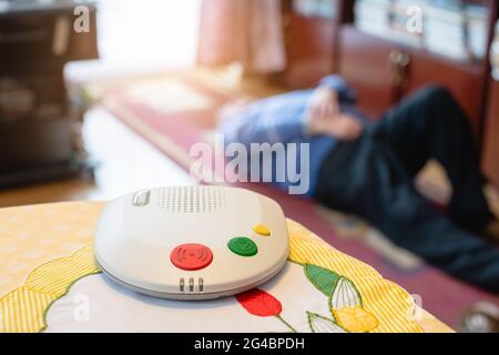 Device delivering emergency single button call for senior man Stock Photo