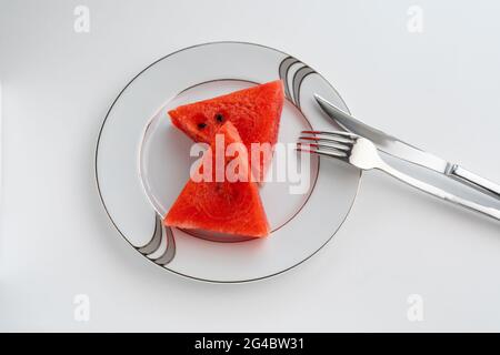 Two slice of watermelon on white plate and white background, elegant style Stock Photo
