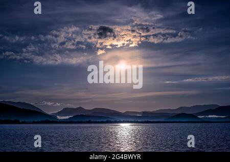 beautiful sea landscape with a sunset. evening sky with clouds and sunshine over ocean. sun rays shine break through clouds Stock Photo