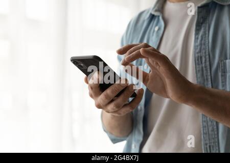 Close up young man using mobile phone applications. Stock Photo