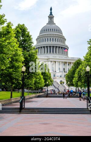Spring Morning at Capitol - A broad sidewalk at west-front of the U.S. Capitol Building on a sunny Spring morning. Washington, D.C., USA. Stock Photo
