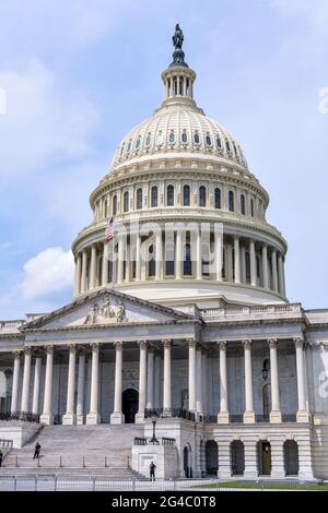 The Capitol Building - Close-up vertical view of east facade of the U.S. Capitol Building, with security officers standing at front of entrance. Stock Photo