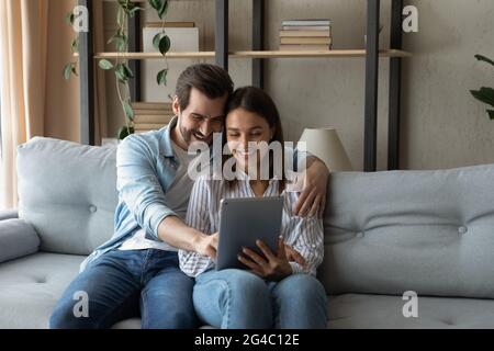 Affectionate bonding happy couple using digital tablet. Stock Photo