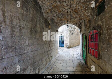 Narrow street with archway and colorful doors and window shutter in the old town of Kotor, Montenegro Stock Photo