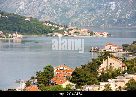 Summer homes on the coastline of the town of Kotor in Kotor Bay, Montenegro Stock Photo