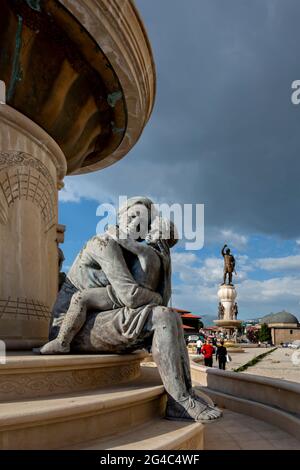Baby Alexander The Great in the arms of his mother Olympias with the statue of his father King Phillip in the background, Skopje, North Macedonia Stock Photo