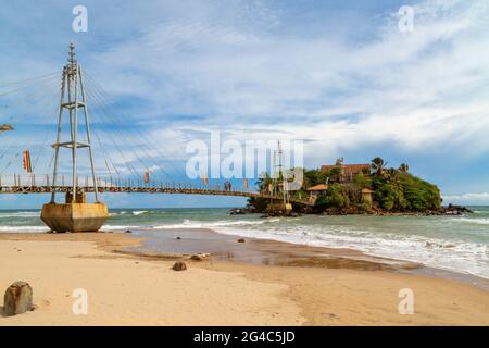 Bridge to the island with a Buddhist temple, Matara, Sri Lanka. Wide ...