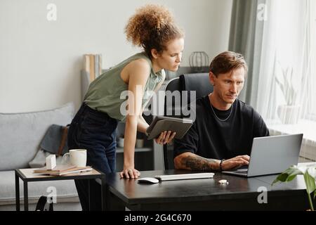 Business people sitting at the table and working on computer they discussing new software in team at office Stock Photo