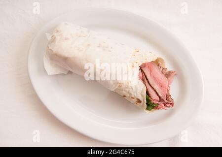 An overhead shot of lamb wrap in a soft homemade flatbread Stock Photo