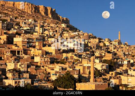 View over the old city of Mardin with full moon in the sky, Turkey. Stock Photo