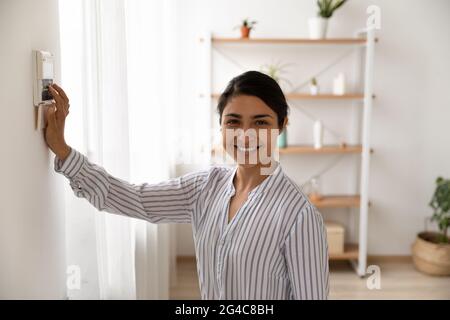Portrait of smiling Indian woman use security system Stock Photo