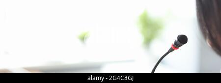 Man standing in front of microphone at conference closeup Stock Photo