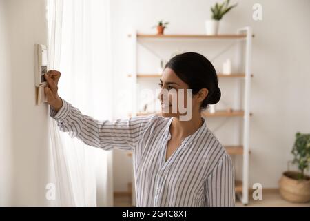 Young Indian woman use security system panel at home Stock Photo