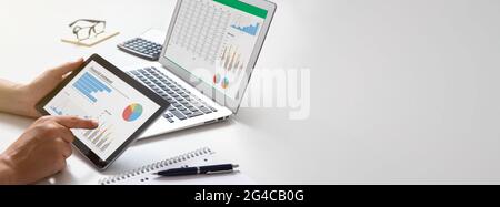 Analyst works with the data. Graphs on the screen Stock Photo