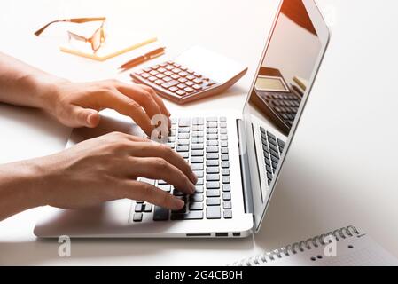 Man using laptop, accountant working in the office, analyzing data Stock Photo