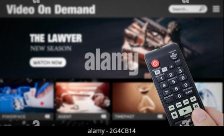 Video on demand, TV streaming, multimedia. Hand holding remote control Stock Photo