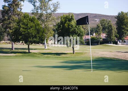 Golf course - green loan with golf carts, bridges, landscaping, clubs and golfers. Stock Photo