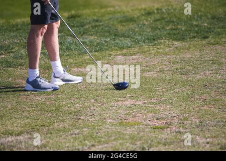 Golf course - green loan with golf carts, bridges, landscaping, clubs and golfers. Stock Photo