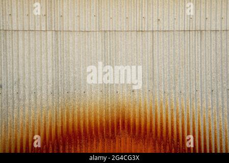 Rusty roller industrial wall with a semi-circular rusty brown area at the bottom Stock Photo