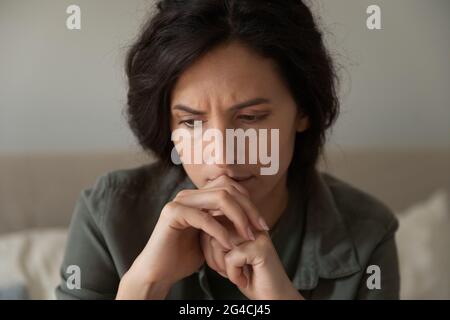 Close up of unhappy frustrated woman thinking about problems Stock Photo