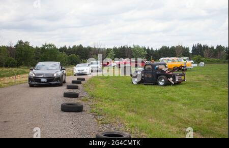 Milton, Canada. 20th June, 2021. People drive their vehicles to attend the 2021 Mega Wheels Drive-Thru event in Milton, Ontario, Canada, on June 20, 2021. The drive-thru event, held from June 18 to 27, features monster trucks, classic cars, military vehicles and more through a 2.5 km course. Credit: Zou Zheng/Xinhua/Alamy Live News Stock Photo